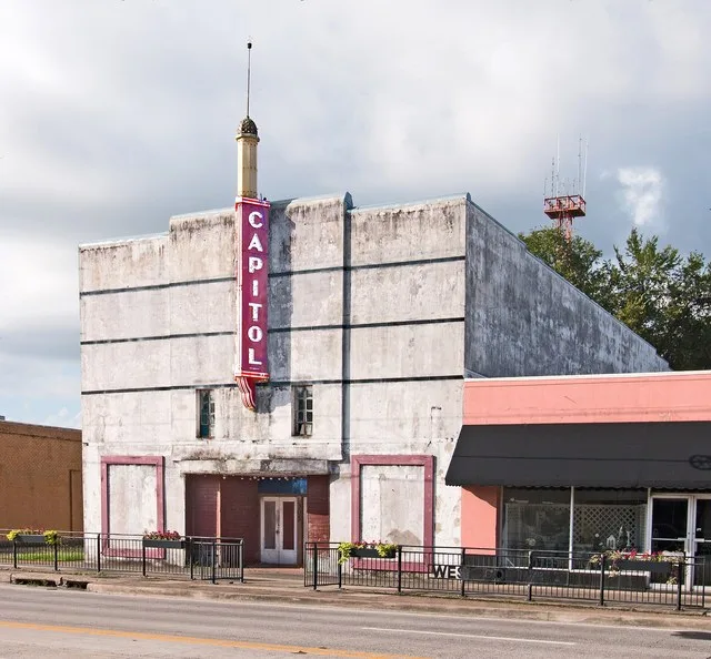 In the city of West Columbia, Texas. The theatre was opened in 1937, and was designed by architect Ernest L. Shult. By 1941 it had been renamed Capitol Theatre.