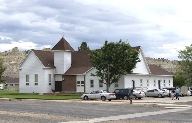 A family arrives for Sunday morning services at a meetinghouse of The Church of Jesus Christ of Latter-day Saints , in Cannonville, Utah.