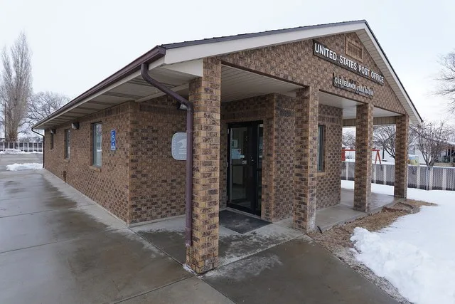 The photograph is of the United States Post Office for Cleveland, Utah. Photograph taken on 2019-02-18T00:15:46Z.