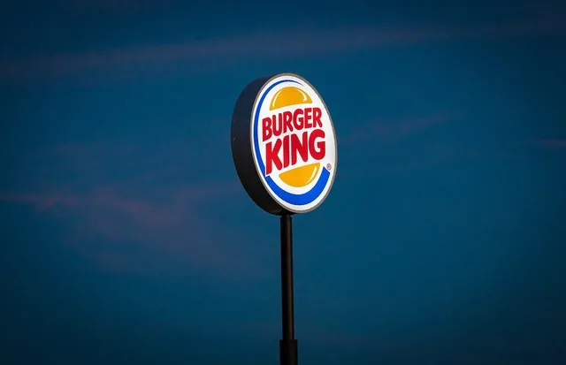 A Burger King fast food restaurant illuminated sign in Farr West near Salt Lake City, Utah.