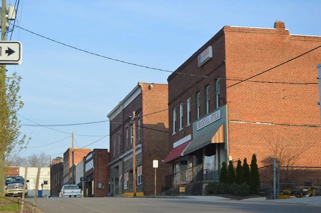 Buildings on the southern side of Rush Street in central Brookneal , Virginia , United States . This block is part of the Brookneal Historic District , a historic district that is...