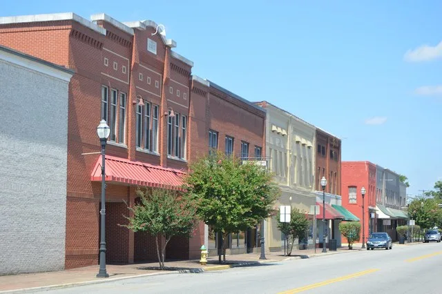 Buildings on the western side of Main Street ( State Route 49 ) at Walker Street in central Chase City , Virginia , United States .
