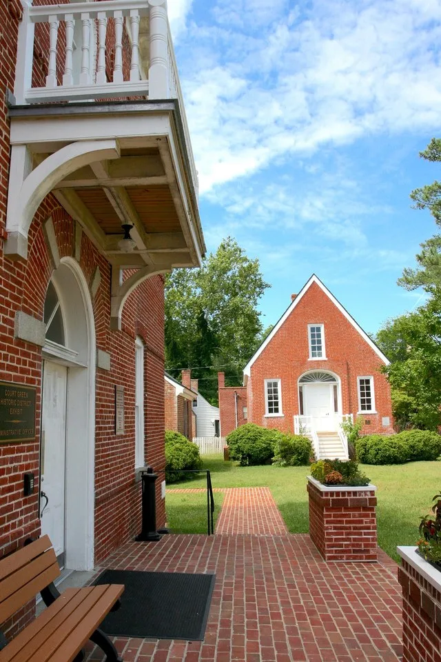 The 1899 Northampton County Courthouse (left) and earlier 1732 Courthouse on the historic court green in Eastville, Virginia.