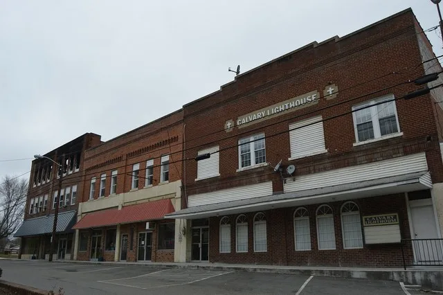 Buildings on Railroad Avenue just west of Main Street in downtown Honaker , Virginia , United States . This block is part of the Honaker Commercial Historic District , a historic...
