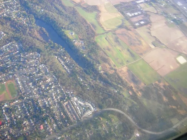 Original caption : " Airborne over Algona, Washington " Specifically appears to be Lake Fenwick, which straddles the border of Kent, Washington.