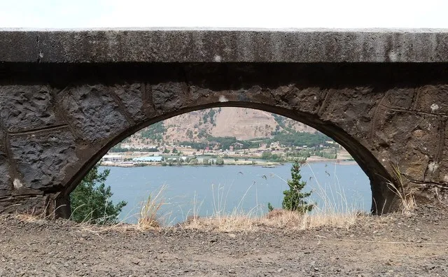 The Rock Slide Viaduct carries the Historic Columbia River Highway across a mountainside above the Columbia River a few miles east of Hood River , Oregon , United States . The via...