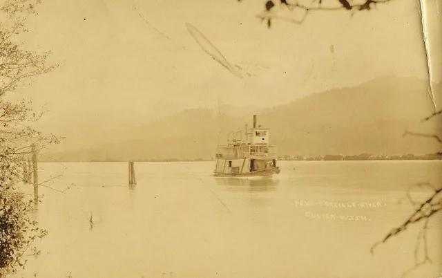 Stern-wheel steamboat on the Pend Oreille River, near Cusick, WA. From an old postcard.