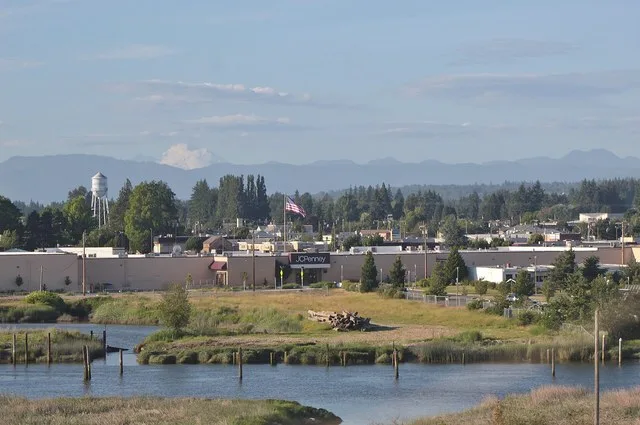 The skyline of downtown Marysville seen from a bus on Interstate 5 over the Ebey Slough. Mount Baker can be seen in the background.