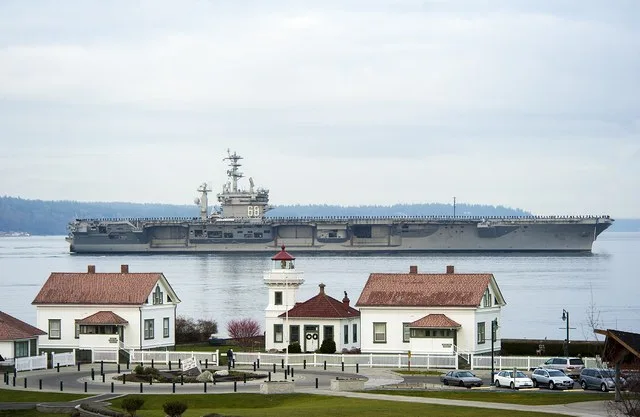 131216-N-AE328-042 EVERETT, Wash. (Dec. 16, 2013) The aircraft carrier USS Nimitz (CVN 68) passes by Mukilteo Lighthouse Park on its way to homeport at Naval Station Everett. Nimi...