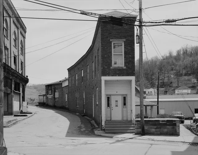 Northern front of the Curved Building, located at 2 Main Street in Cameron , West Virginia , United States . The building to the left is now gone, and the narrow street between th...