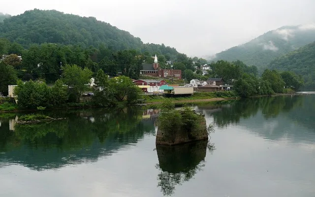 Looking across the Gauley River at the town of Gauley Bridge . The pilings in the foreground are the remains of the Civil War -era covered bridge that gave the town its name. The...