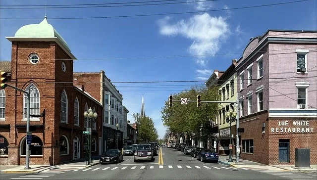Facing north on Queen Street (at the intersection with Burke Street) in Martinsburg, West Virginia. The buildings are contributing properties to the Downtown Martinsburg Historic...