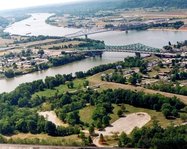 The confluence of the Kanawha and Ohio Rivers. The Kanawha River flows in from the left of the picture and joins the Ohio, meandering off in the distance. The town of Point Pleasa...