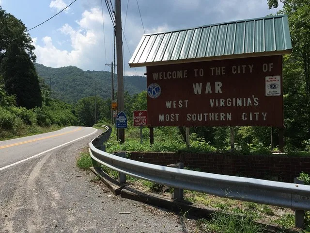 "Welcome to the City of War" sign along southbound West Virginia State Route 16 (Main Street) at Excelsior A Road (McDowell County Route 102/08) in War, McDowell County, West Virg...
