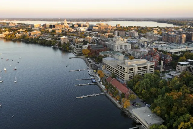 The Lake Mendota shoreline is pictured in an aerial view of the University of Wisconsin-Madison campus looking toward the downtown Madison skyline during an autumn sunset on Oct...