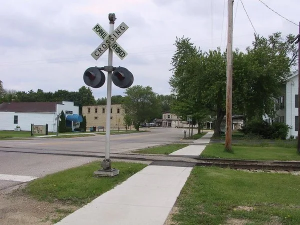 The old railroad tracks in downtown McFarland, Wisconsin. The road in the picture has recently been paved over with asphalt.