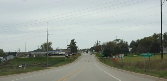 Looking west at the sign for w:Montfort, Wisconsin while traveling on w:U.S. Route 18 / w:Wisconsin Highway 80 .