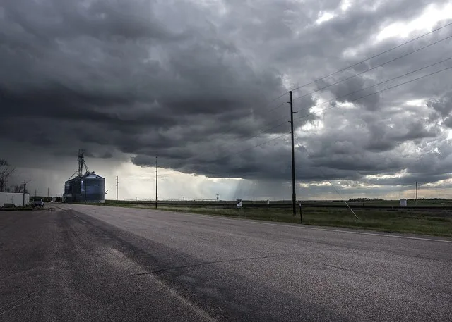 Title: Ominous clouds above Pine Bluffs, a small farming community on the Nebraska border in Laramie County, Wyoming Physical description: 1 photograph : digital, tiff file, color...