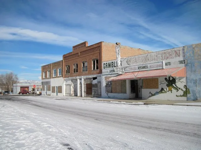 Abandoned downtown building on the east side of the 100 block of Main Street in Shoshoni, Wyoming . This once booming economic downtown has been reduced by time and shifts in trad...